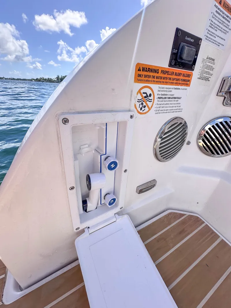 Slide: The Image of 2019 Regal 33 OBX boat deck with control panel and warning labels. - 41