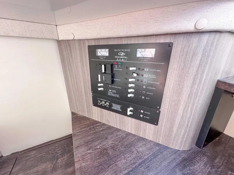 Slide: The Image of Control panel of a 2019 Regal 33 OBX boat, featuring various switches and indicators. - 42