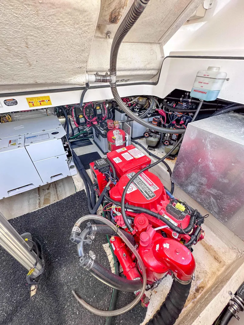 Slide: The Image of Engine compartment of a 2019 Regal 33 OBX boat, showcasing red engine and wiring. - 46