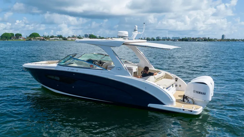Slide: The Image of 2019 Regal 33 OBX boat cruising on a sunny day with Yamaha engines. - 8
