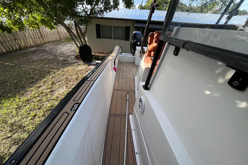 Slide: The Image of 1993 Cape Horn 27 boat with teak deck, parked beside a house. - 11