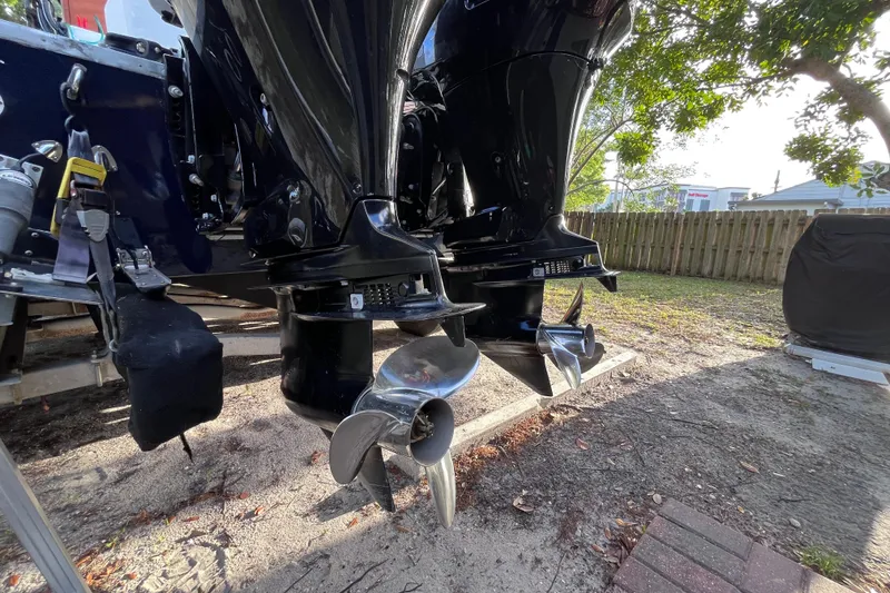 Slide: The Image of Twin outboard motors on a 1993 Cape Horn 27 boat, parked outdoors. - 14