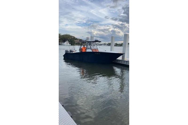 Slide: The Image of Cape Horn 27 boat from 1993 docked at a marina under a cloudy sky. - 15