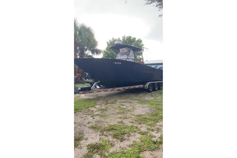 Slide: The Image of 1993 Cape Horn 27 boat on trailer, parked outdoors with trees in background. - 16