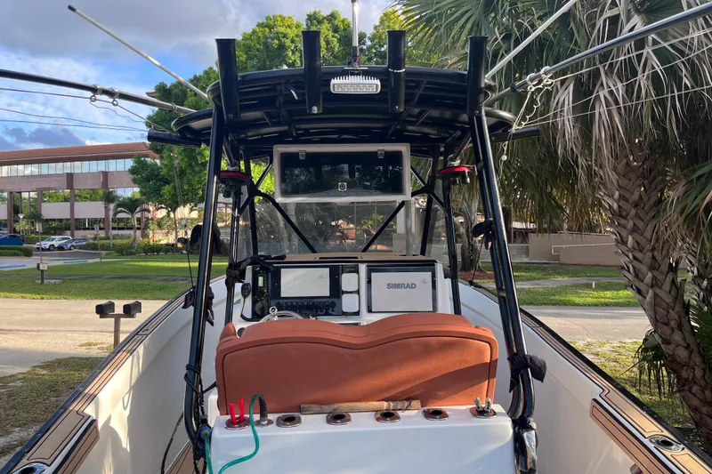 Slide: The Image of 1993 Cape Horn 27 boat cockpit with Simrad electronics, surrounded by palm trees. - 6
