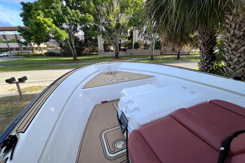 Slide: The Image of 1993 Cape Horn 27 boat interior with seating and storage, surrounded by trees. - 9