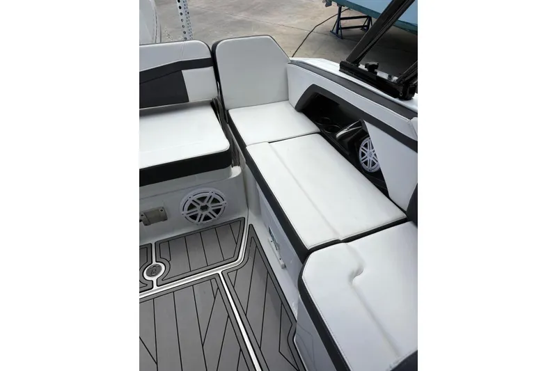 Slide: The Image of 2023 Monterey 255SS Super Sport boat interior with white seating and gray flooring. - 10