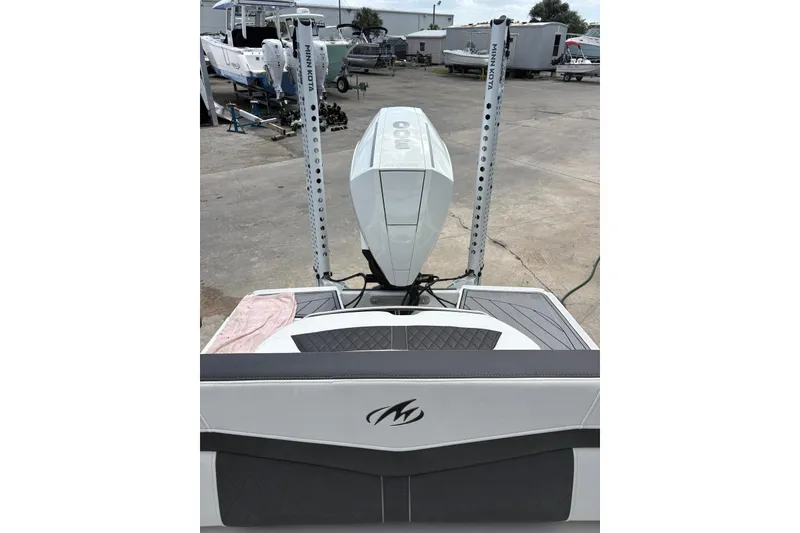 Slide: The Image of 2023 Monterey 255SS Super Sport boat with Minn Kota trolling motor in a marina setting. - 13