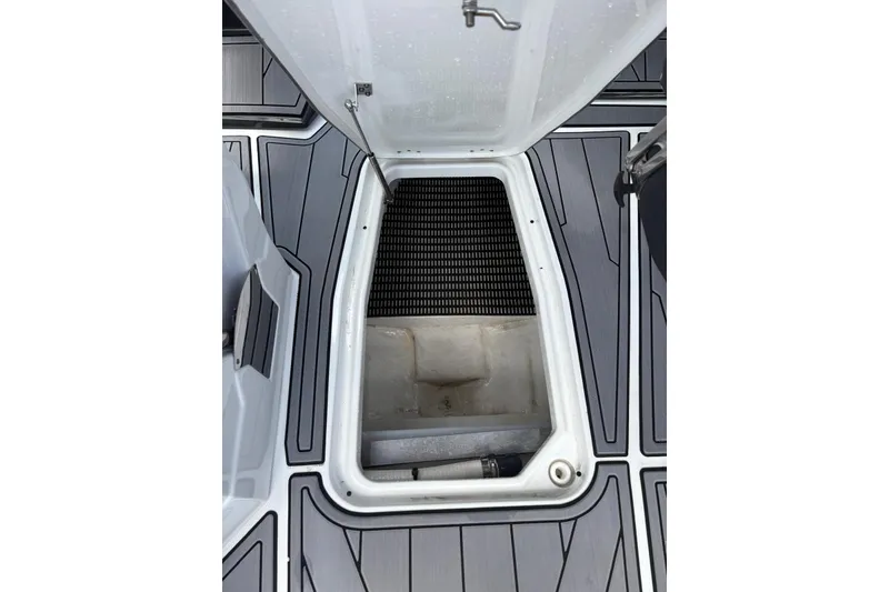 Slide: The Image of Open storage compartment on 2023 Monterey 255SS Super Sport boat deck. - 14