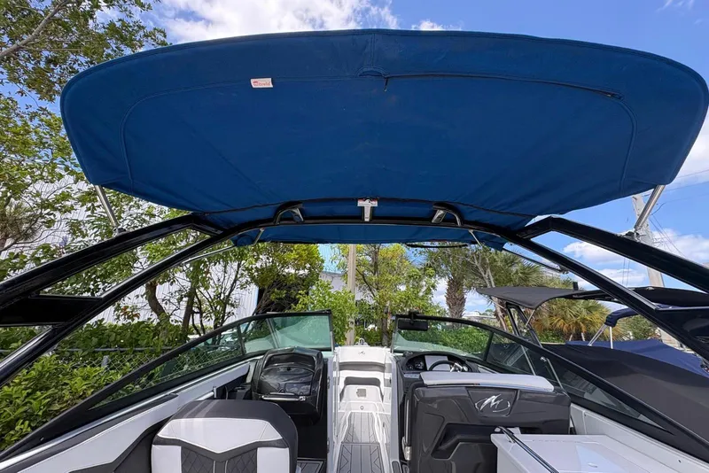 Slide: The Image of 2023 Monterey 255SS Super Sport boat interior with blue canopy and sleek design. - 16