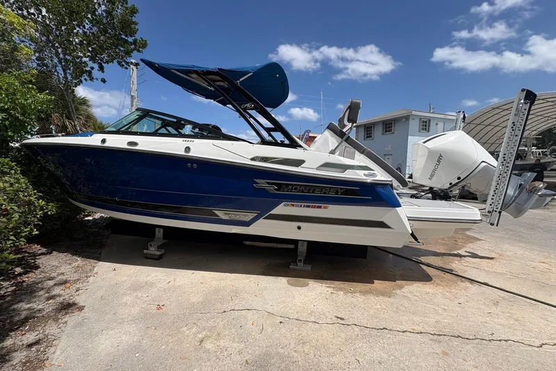 Slide: The Image of 2023 Monterey 255SS Super Sport boat on dry dock under a clear blue sky. - 2