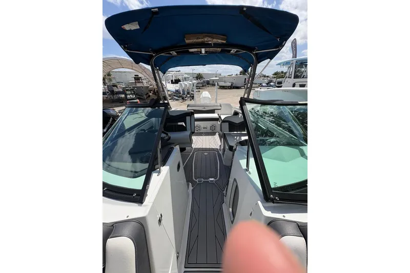 Slide: The Image of 2023 Monterey 255SS Super Sport boat interior with blue canopy and sleek design. - 21