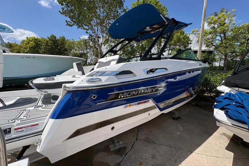 Slide: The Image of 2023 Monterey 255SS Super Sport boat in blue and white, docked outdoors. - 3