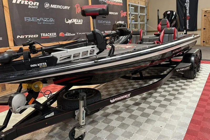Slide: The Image of 2021 Phoenix 920 Elite boat on display in showroom with branded backdrop. - 3