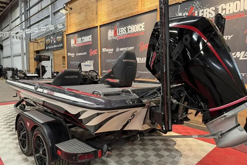 Slide: The Image of 2021 Phoenix 920 Elite boat displayed indoors with powerful engine and sleek design. - 4