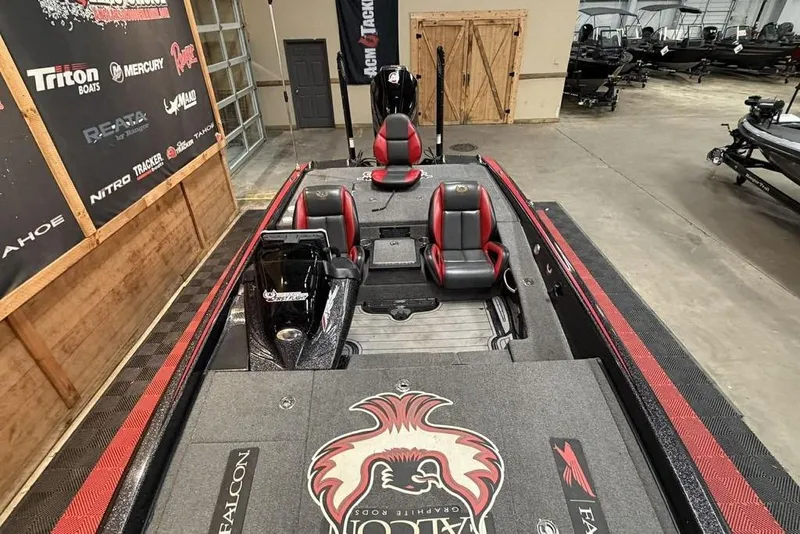 Slide: The Image of 2021 Phoenix 920 Elite boat with red and black seating in a showroom. - 6