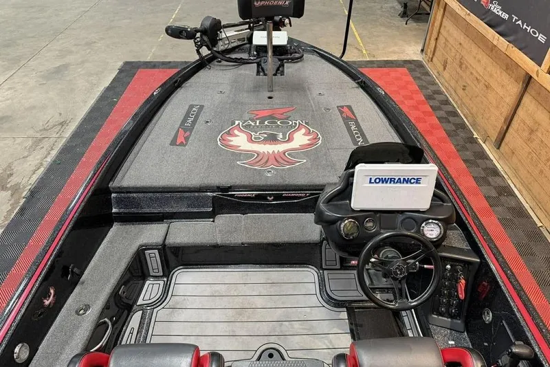 Slide: The Image of 2021 Phoenix 920 Elite boat interior with Falcon branding and Lowrance navigation system. - 7