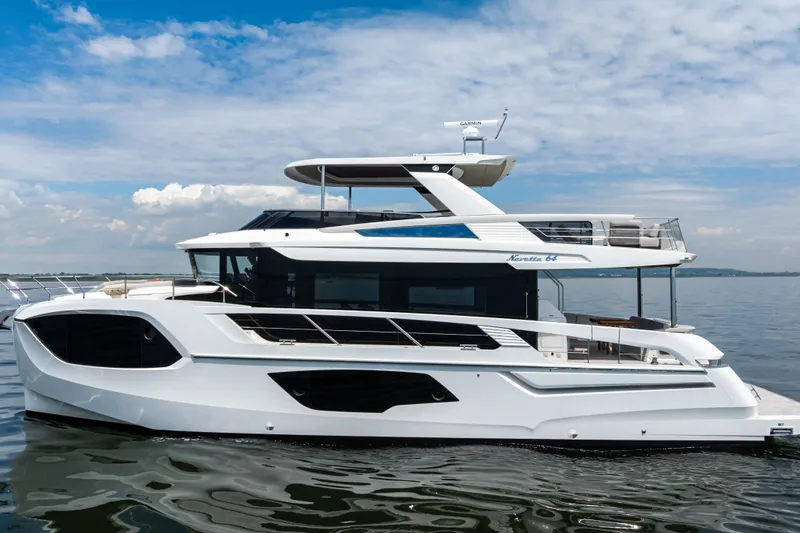 The Image of 2025 Absolute Navetta 64 yacht on calm water under a blue sky. - 0