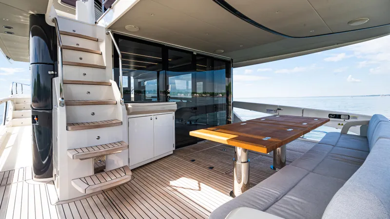 Slide: The Image of Outdoor deck of 2025 Absolute Navetta 64 yacht with seating and table. - 15