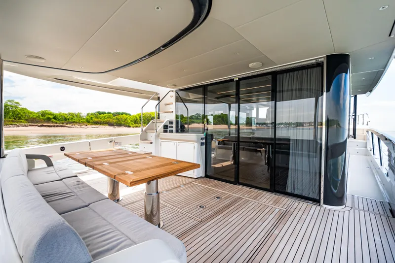 Slide: The Image of Luxury deck of 2025 Absolute Navetta 64 yacht with seating and dining area. - 16