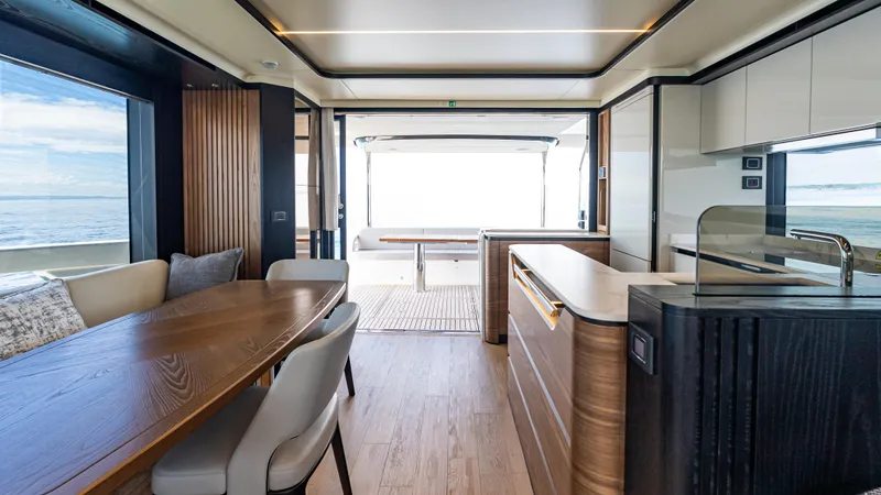 Slide: The Image of Luxurious interior of 2025 Absolute Navetta 64 yacht with modern dining and kitchen area. - 22