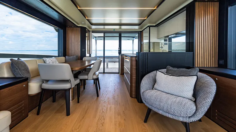 Slide: The Image of Luxurious interior of 2025 Absolute Navetta 64 yacht with elegant seating and panoramic views. - 23