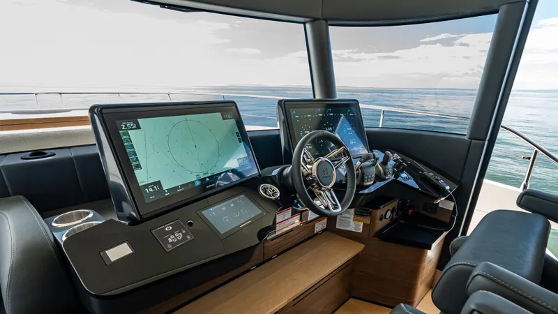 Slide: The Image of Helm of 2025 Absolute Navetta 64 yacht with advanced navigation displays. - 35