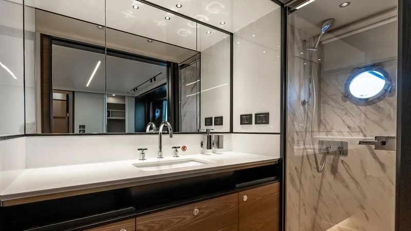 Slide: The Image of Luxurious bathroom in 2025 Absolute Navetta 64 yacht with modern fixtures and elegant design. - 45