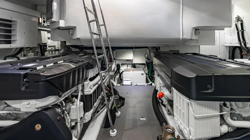 Slide: The Image of Engine room of 2025 Absolute Navetta 64 yacht, featuring dual engines and modern equipment. - 53