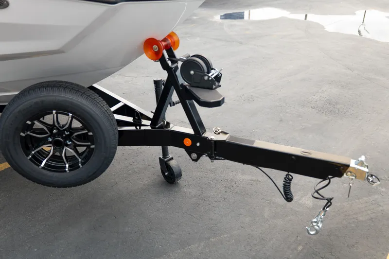 Slide: The Image of Trailer hitch of 2026 MasterCraft NXT23 boat on pavement. - 10