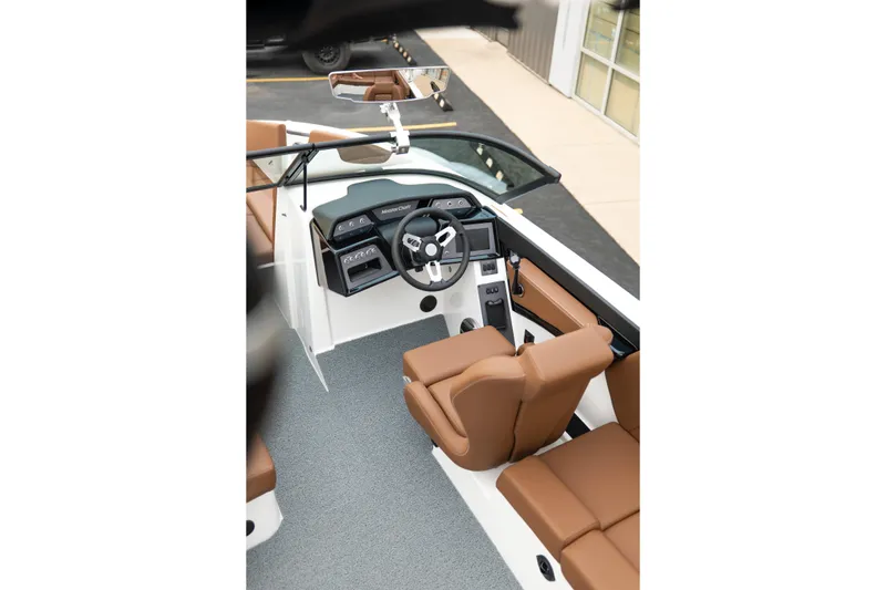 Slide: The Image of 2026 MasterCraft NXT23 boat interior with brown seating and modern dashboard. - 16