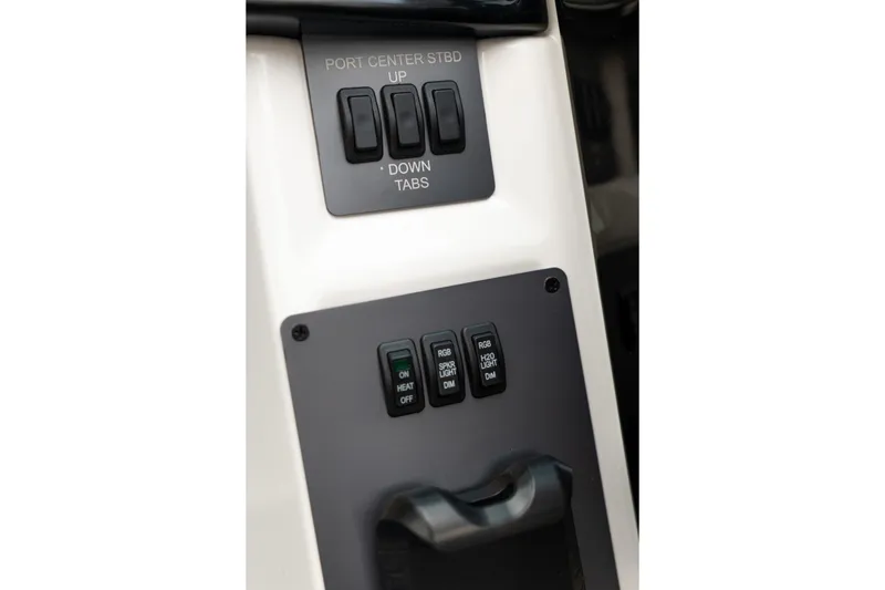 Slide: The Image of Control panel of 2026 MasterCraft NXT23 boat with various switches and buttons. - 19