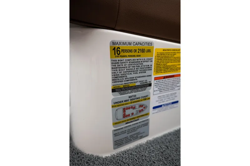 Slide: The Image of Capacity label on 2026 MasterCraft NXT23 boat, indicating 16-person or 2160 lbs limit. - 23