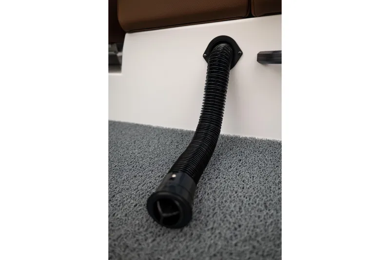 Slide: The Image of Black hose on 2026 MasterCraft NXT23 boat interior, resting on textured carpet. - 24