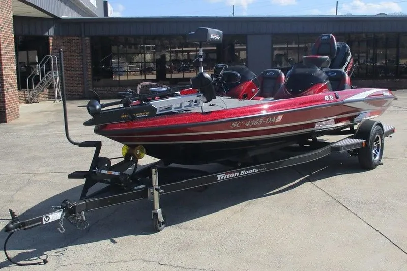 Slide: The Image of 2014 Triton 18XS SC boat on trailer, parked outside a building. - 5
