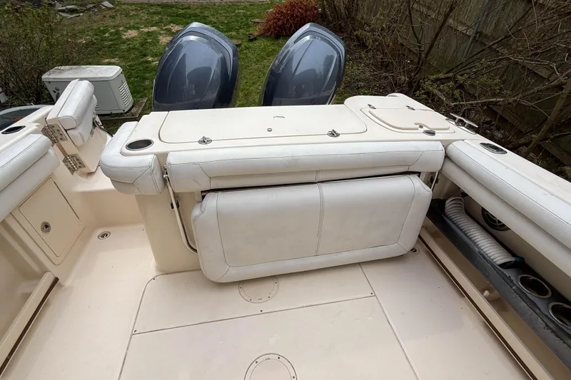 Slide: The Image of 2015 Grady-White Freedom 275 boat interior with seating and storage compartments. - 36