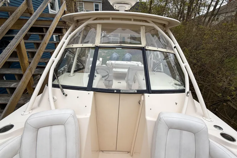 Slide: The Image of 2015 Grady-White Freedom 275 boat with white seating and clear windshield. - 32
