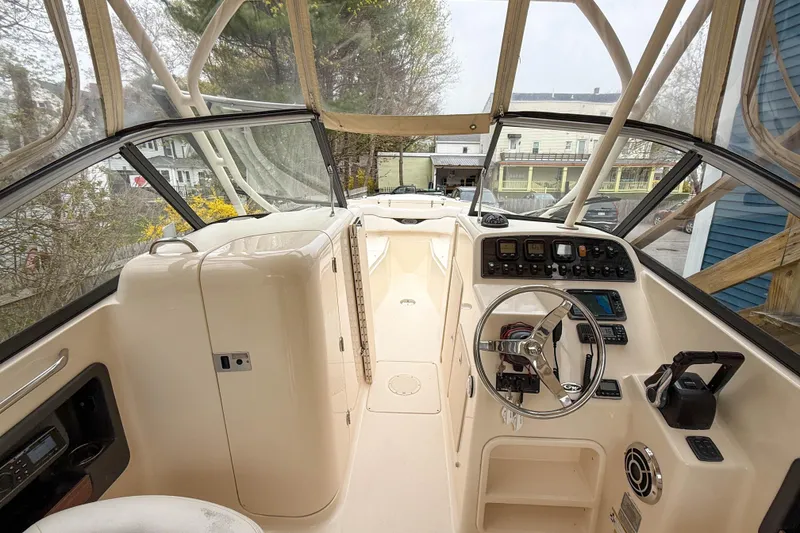Slide: The Image of 2015 Grady-White Freedom 275 boat cockpit with steering wheel and control panel. - 25