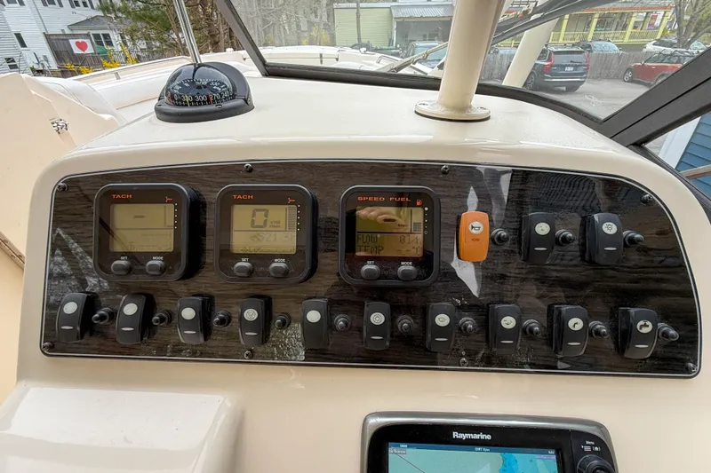 Slide: The Image of Control panel of a 2015 Grady-White Freedom 275 boat with gauges and switches. - 19