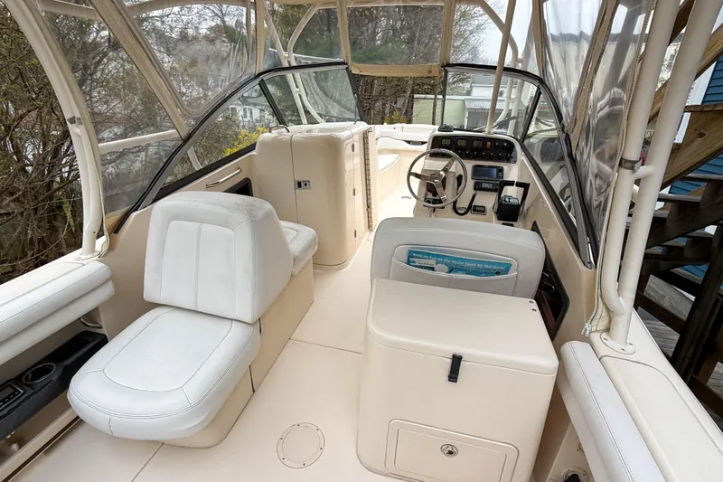 Slide: The Image of 2015 Grady-White Freedom 275 boat interior with seating and steering console. - 13
