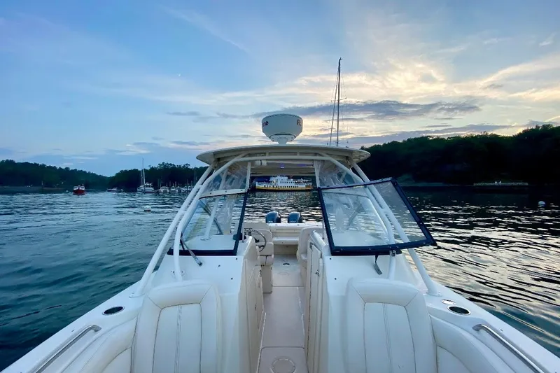 Slide: The Image of 2015 Grady-White Freedom 275 boat on calm water at sunset. - 10