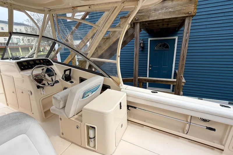 Slide: The Image of 2015 Grady-White Freedom 275 boat interior with helm and seating area. - 46