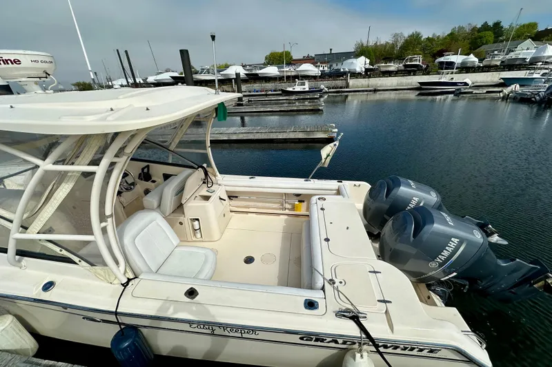 Slide: The Image of 2015 Grady-White Freedom 275 boat docked with twin Yamaha engines. - 5