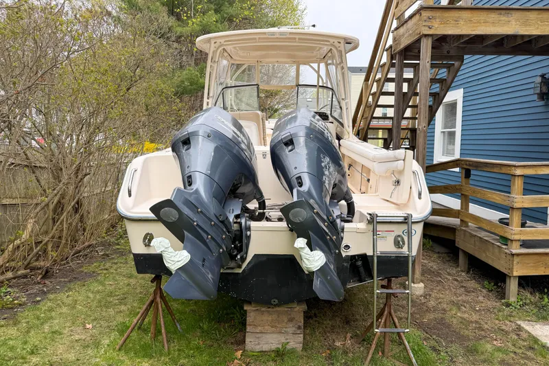 Slide: The Image of 2015 Grady-White Freedom 275 boat with dual outboard motors on a lawn. - 47