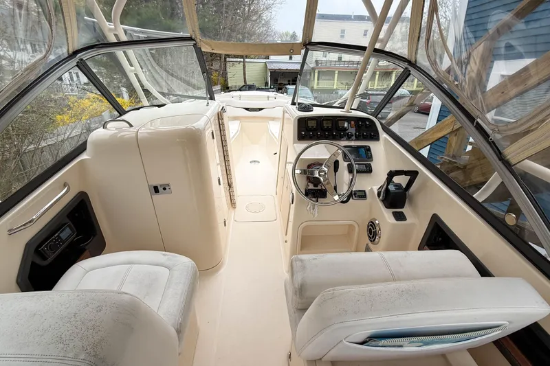 Slide: The Image of 2015 Grady-White Freedom 275 boat interior with steering wheel and control panel. - 15