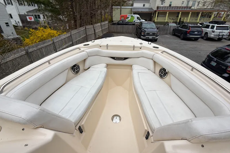 Slide: The Image of 2015 Grady-White Freedom 275 boat interior with white seating and speakers. - 26