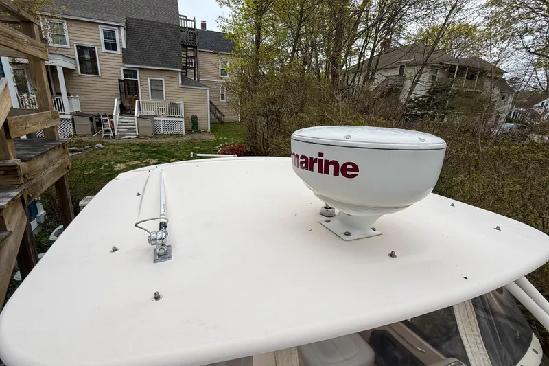Slide: The Image of 2015 Grady-White Freedom 275 boat with radar dome on top, near residential area. - 44
