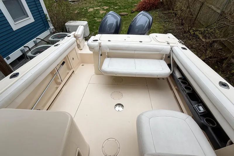 Slide: The Image of 2015 Grady-White Freedom 275 boat interior with seating and dual outboard motors. - 34