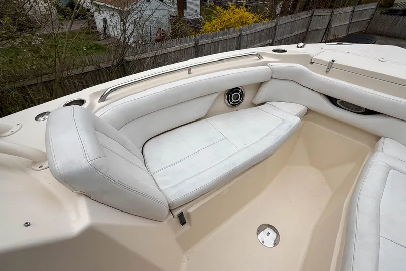 Slide: The Image of 2015 Grady-White Freedom 275 boat interior with white cushioned seating. - 27
