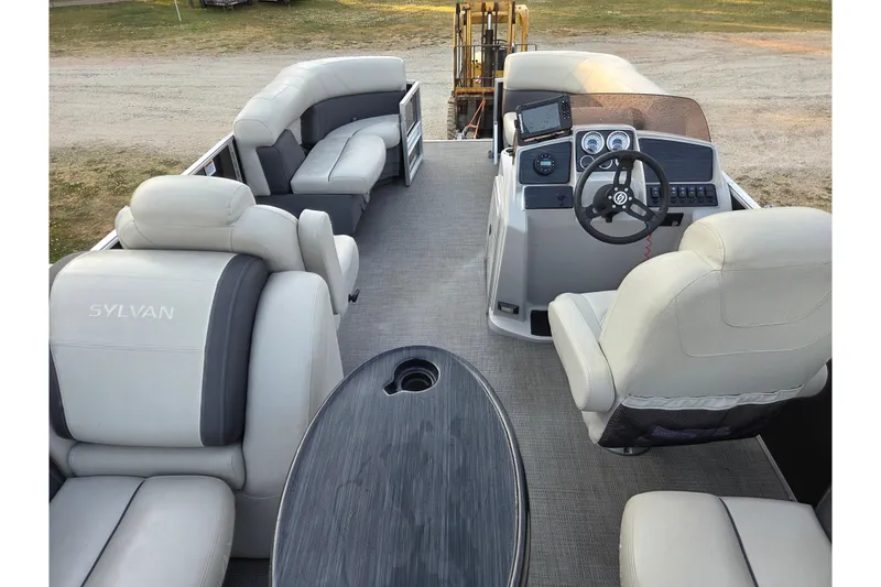 Slide: The Image of 2022 Sylvan Mirage 820 Cruise pontoon boat interior with plush seating and modern helm. - 12